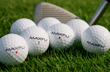 Maxfli golf balls on grass showing brand logo and dimple pattern for review comparison