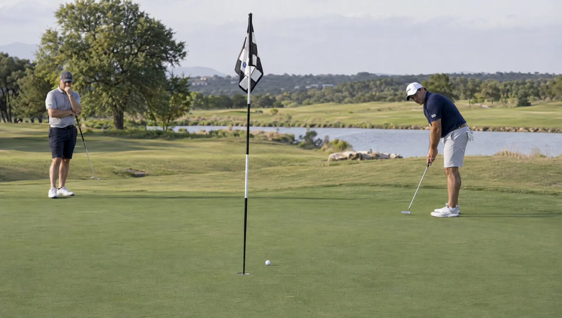 How to Read Golf Greens Before You Line Up a Putt Two golfers observe a putt rolling toward the cup to judge the green's slope and pace.